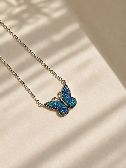 Viorette 925 sterling silver butterfly necklace with a deep blue sapphire-colored stone