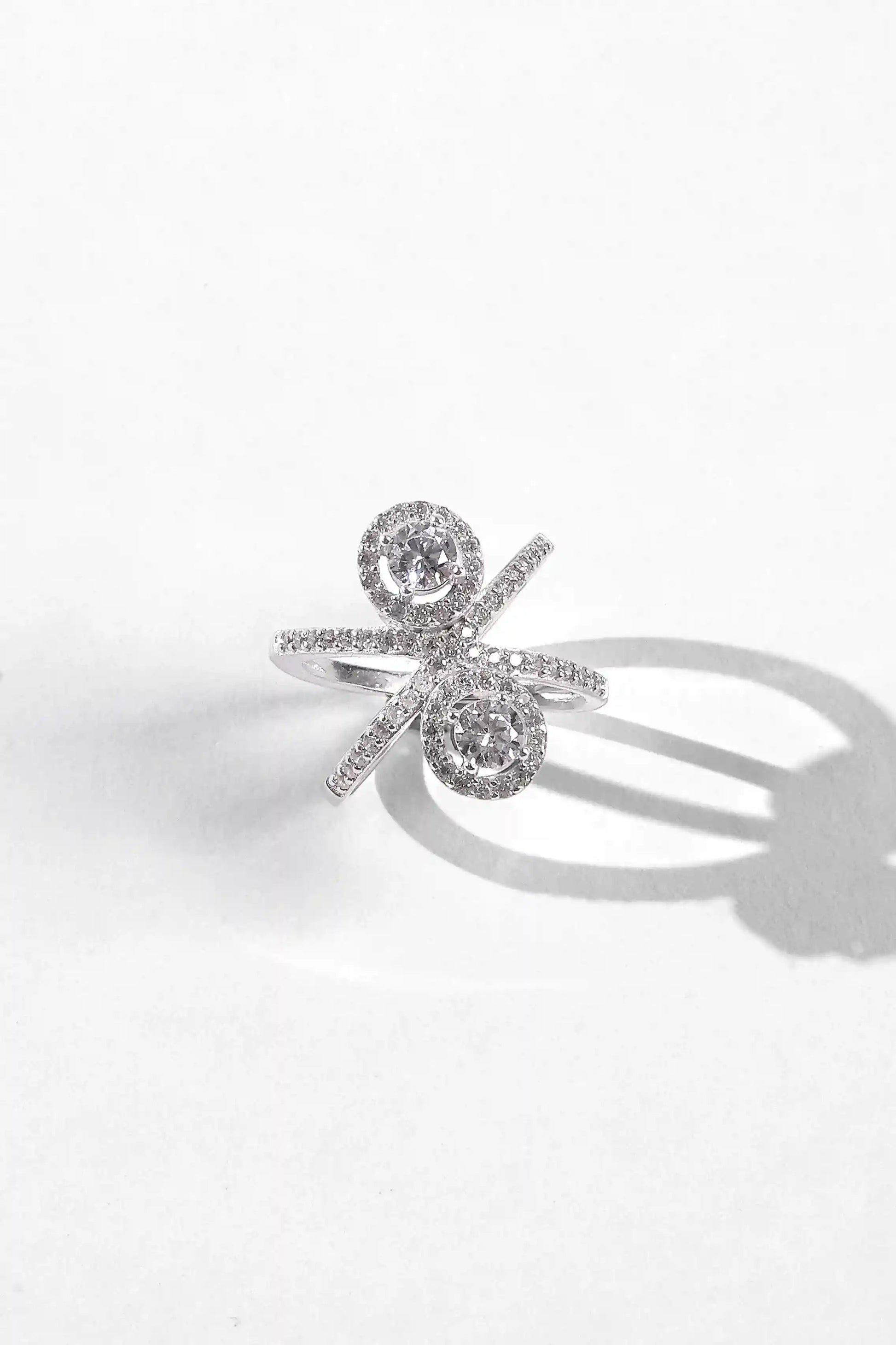 Viorette Twin Halo Crossover ring in 925 sterling silver with two halo-set stones on a crossover band