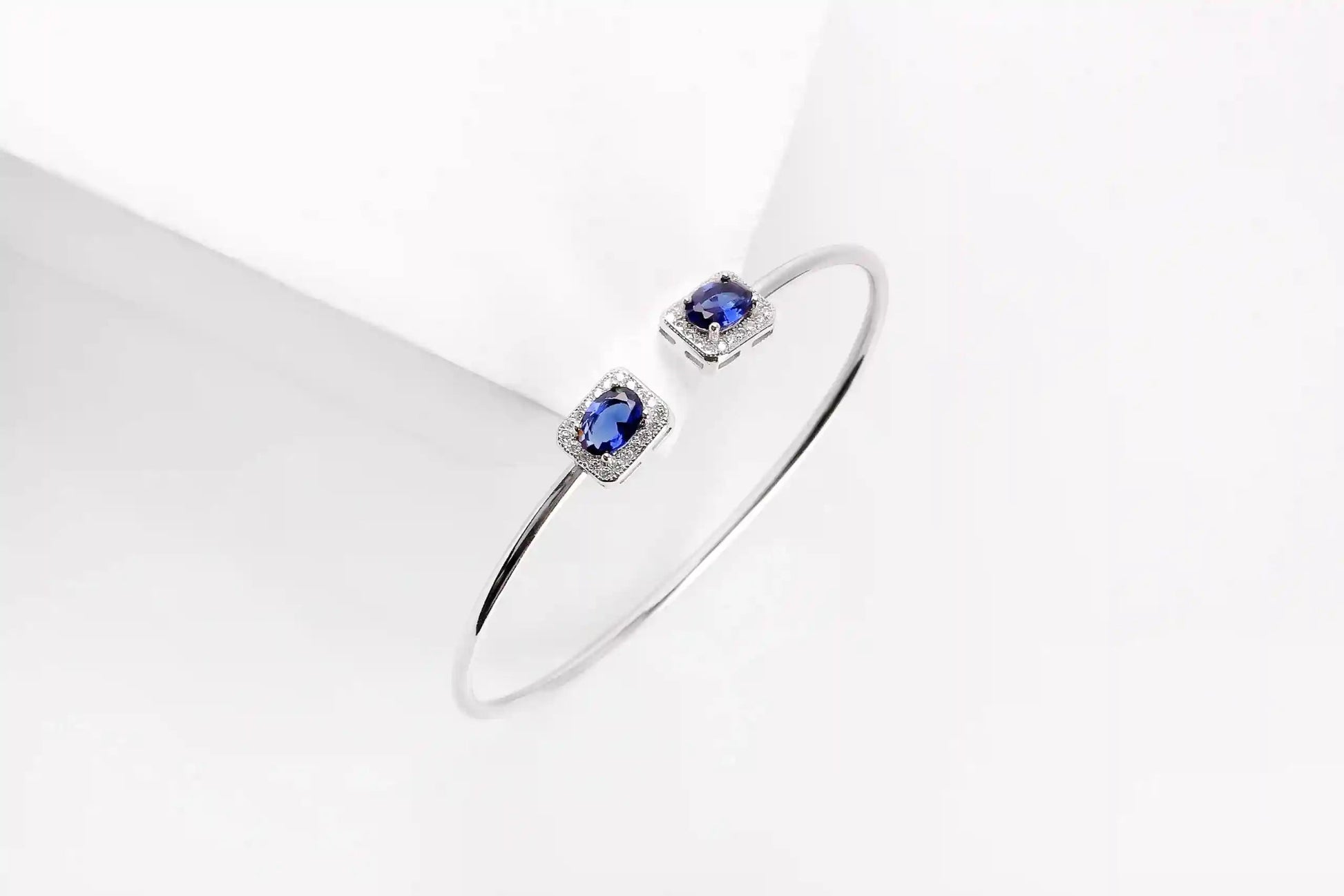 Viorette open bangle in 925 sterling silver with glowing blue zircon stones