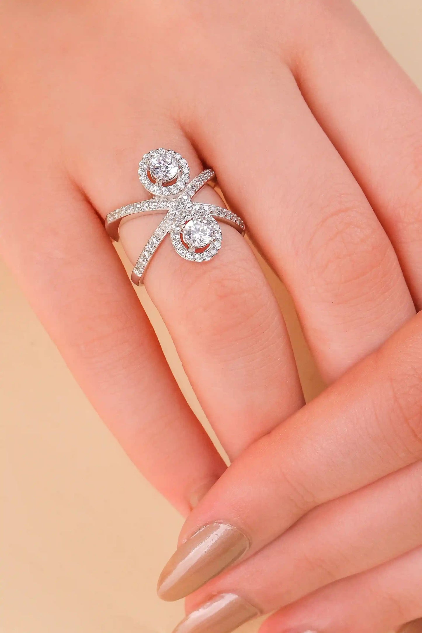 Viorette Twin Halo Crossover ring in 925 sterling silver with two halo-set stones on a crossover band