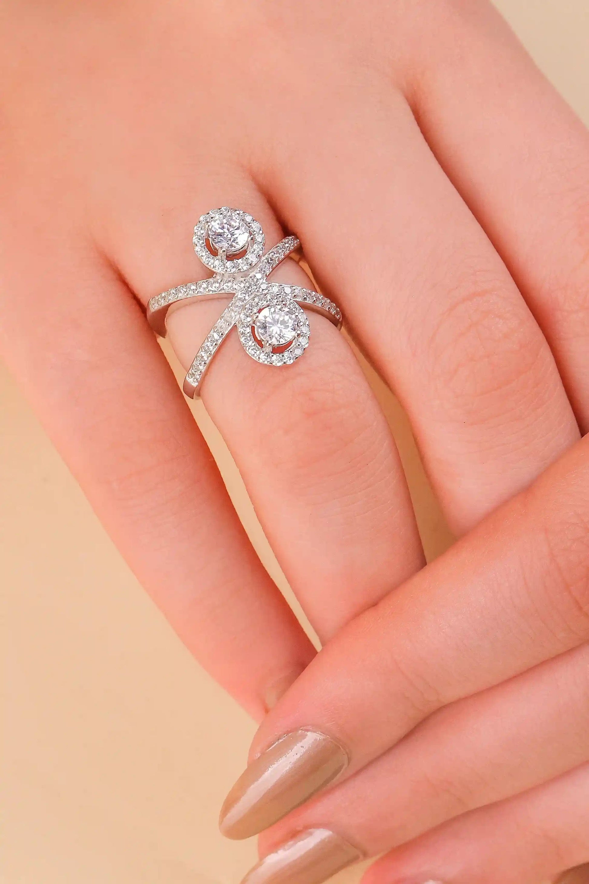 Viorette Twin Halo Crossover ring in 925 sterling silver with two halo-set stones on a crossover band